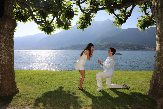Surprise proposal by Lake Como captured by photographer Nadia Fraqair — romantic lakeside moment with emotional reaction and cinematic light