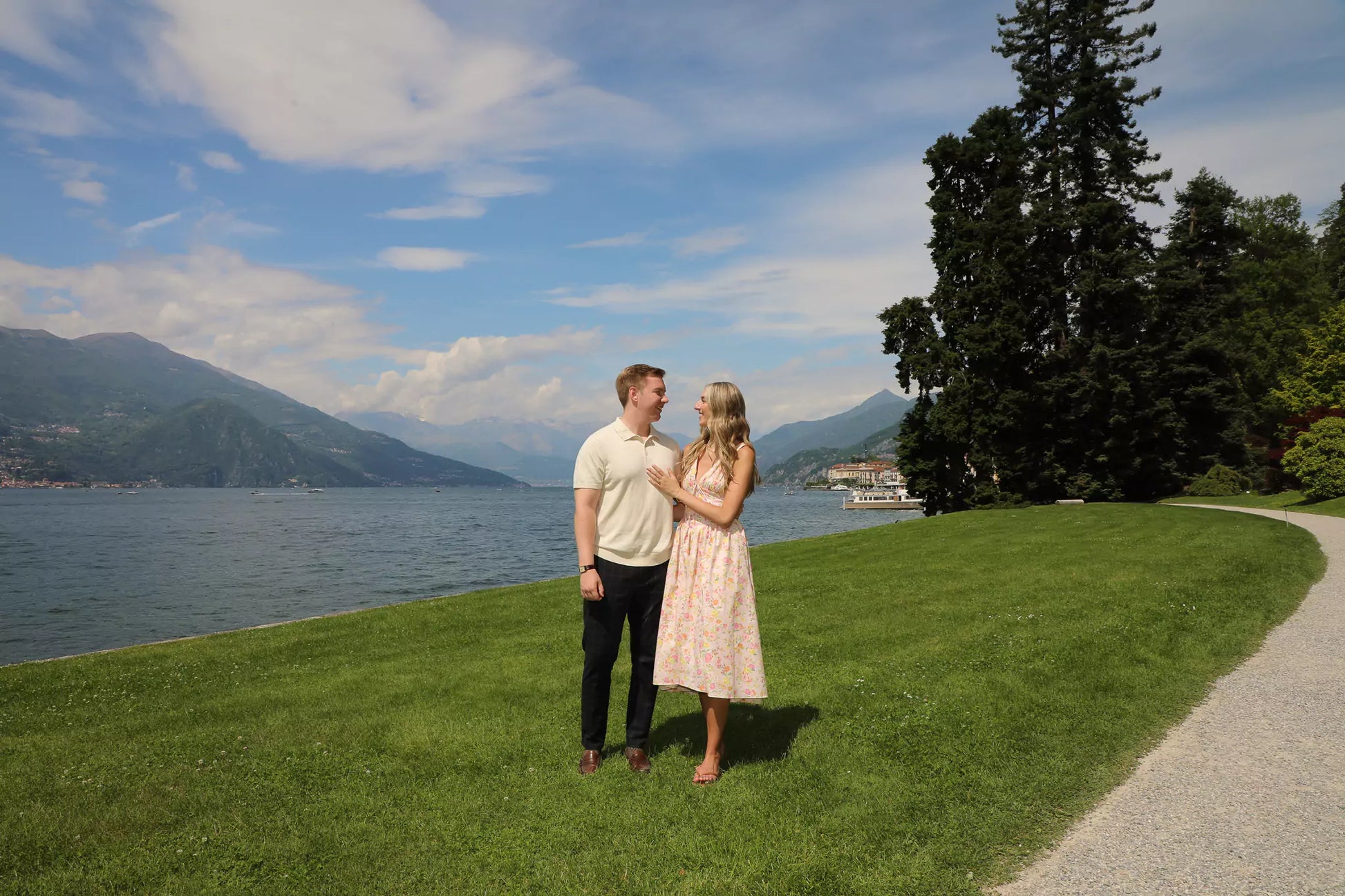 Couple arriving hand-in-hand for a surprise proposal at Villa Melzi Gardens in Bellagio, Lake Como