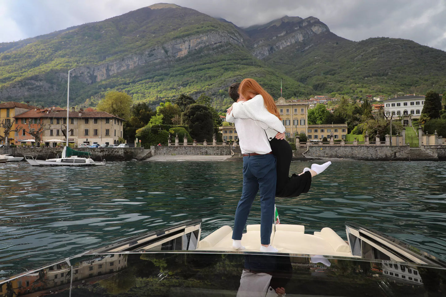 Golden hour proposal on Lake Como with glowing lake reflections