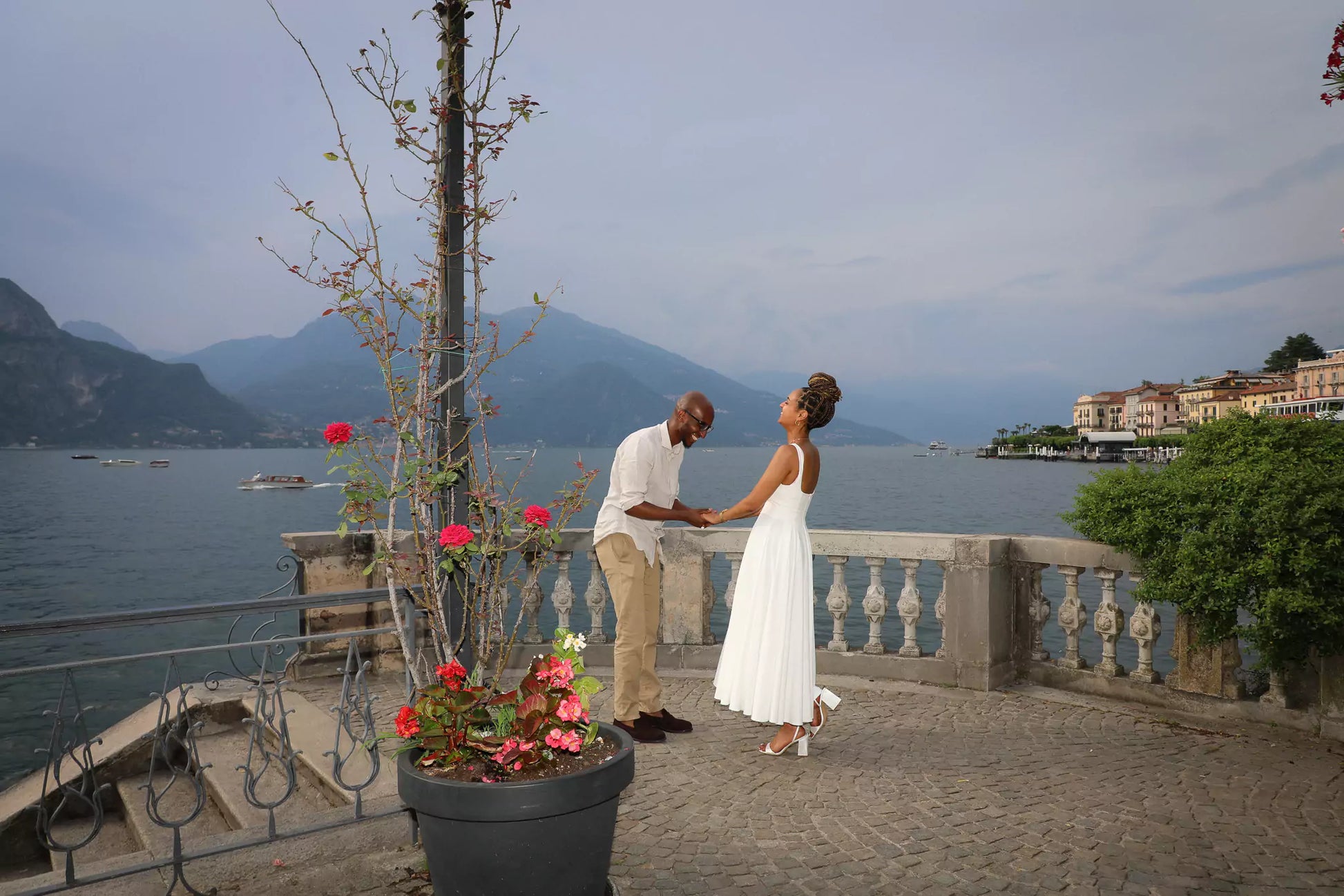 Bride-to-be adjusting her designer dress before proposal session in Lake Como
