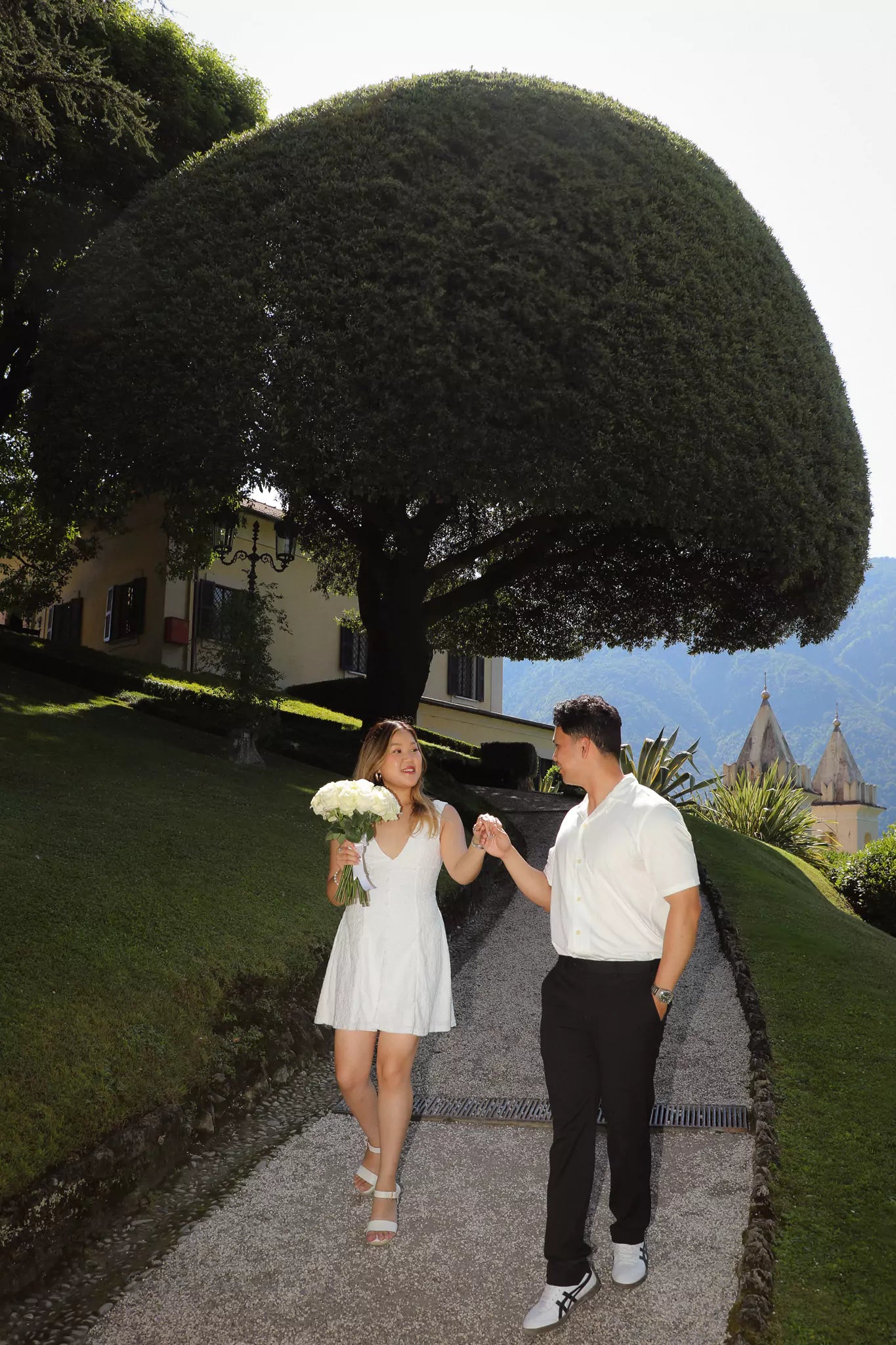 Flat lay of elegant shoes and floral bouquet from Lake Como proposal styling package
