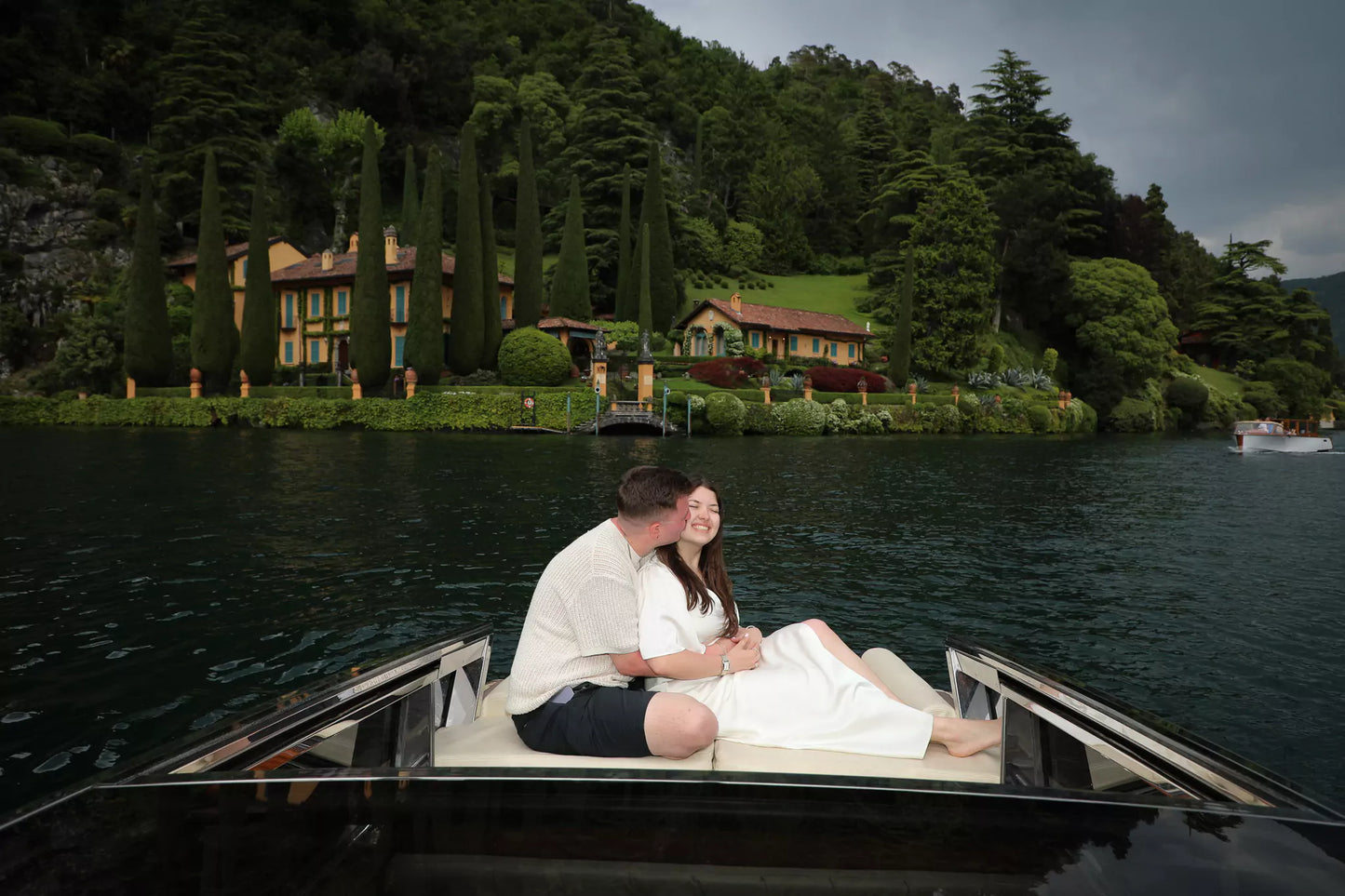 Couple enjoying romantic boat ride on Lake Como before proposal