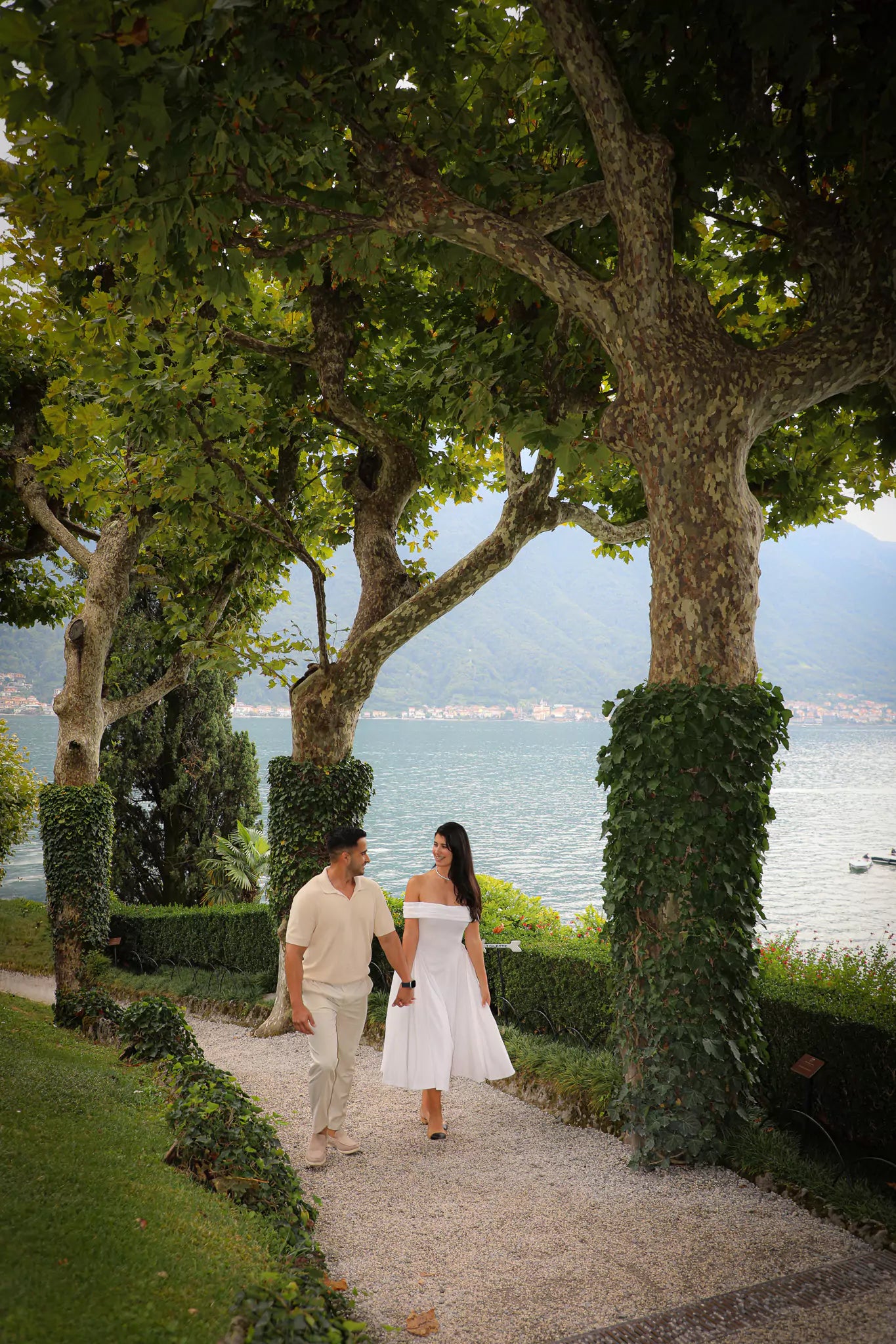 Couple walking hand-in-hand through the gardens of Villa Balbianello after their Lake Como proposal